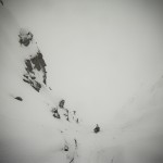 Aaron just below the choke to the summit ridge. This is the section my crampon kicked off..