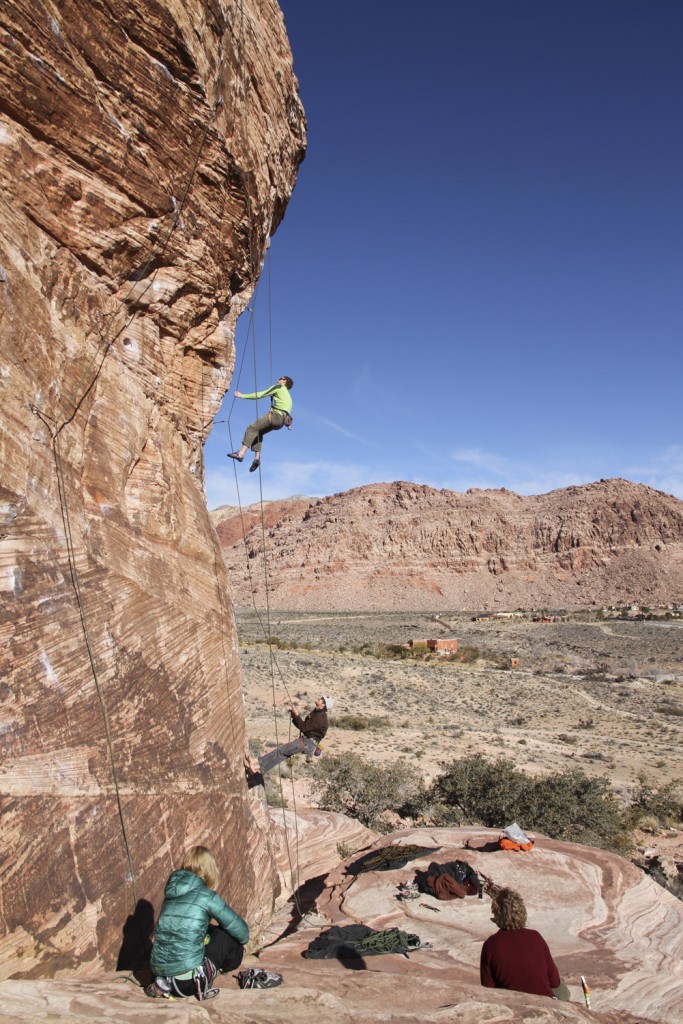 Ben climbing Caustic (5.11b) with a belay from Will as Robyn and I look on.
