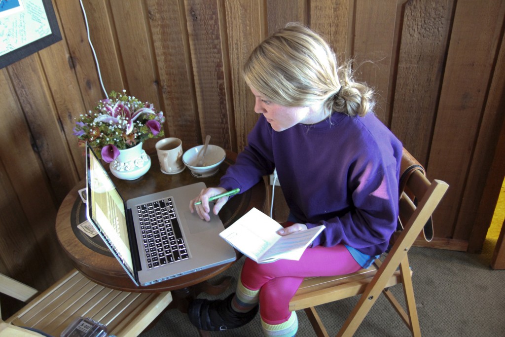 Robyn checking the bulletin over a cup of coffee as the sun pokes through the kitchen window.