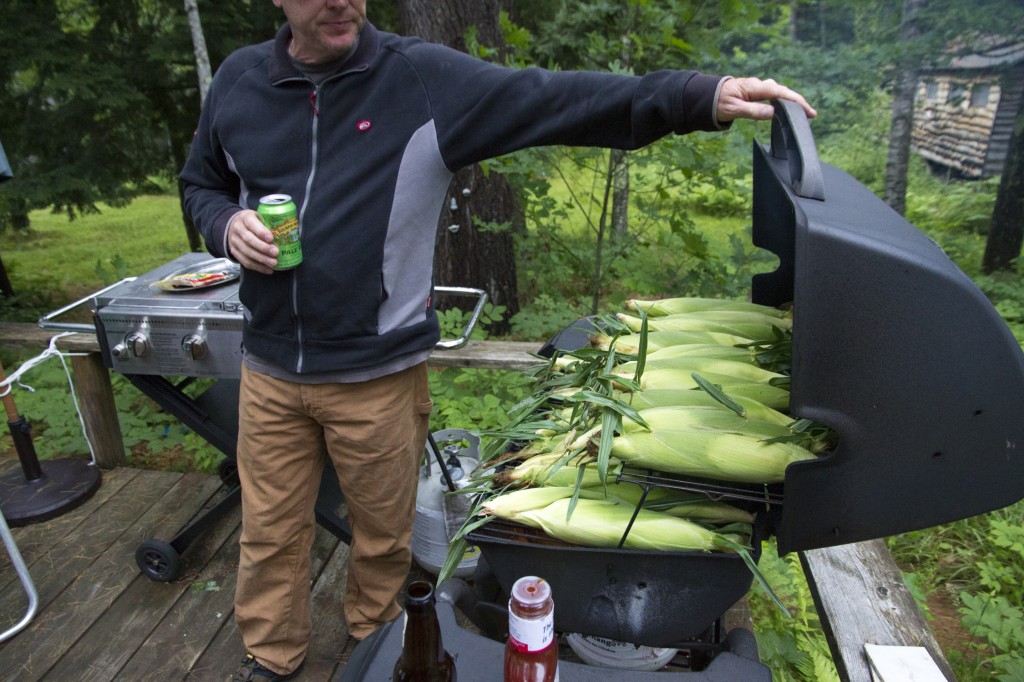 Dad cookin' corn on the cob in the BBQ.