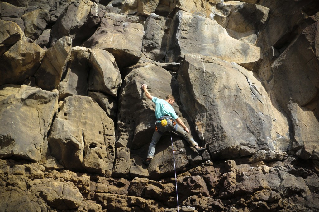 Pat in the crux of Sanitary Landfill (5.10b) at The Alcove.