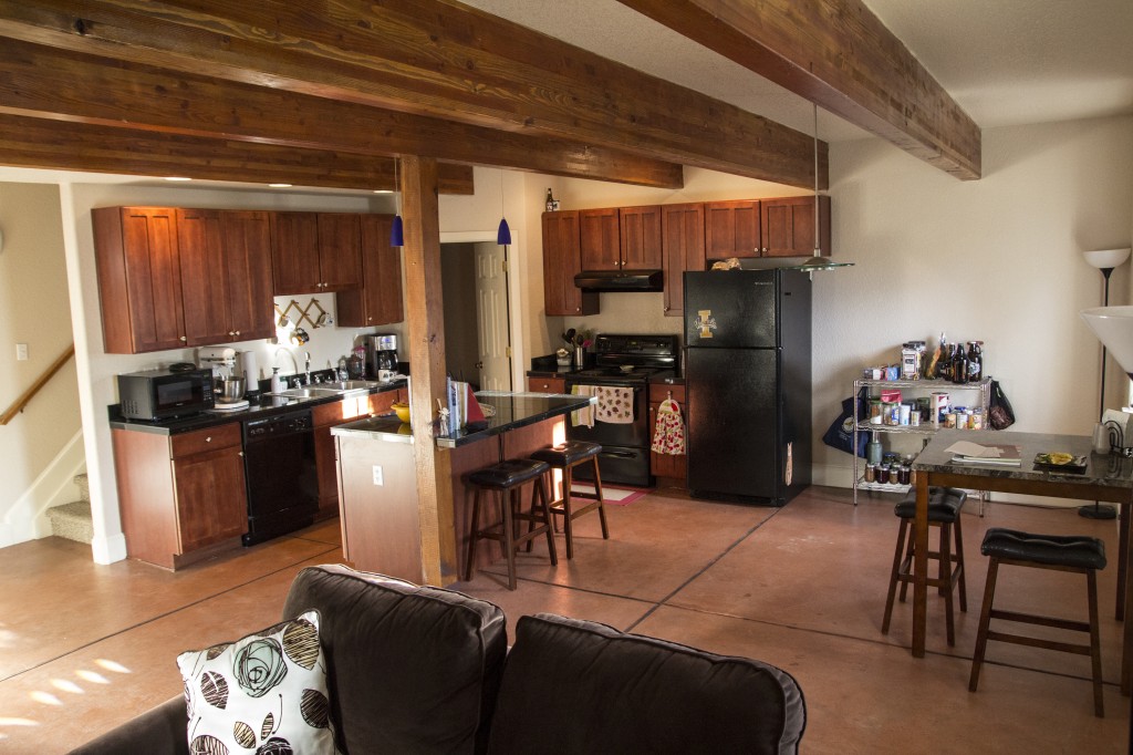 The kitchen as seen from the living room. The stairs lead up to the bedrooms, bathroom and a small laundry room.