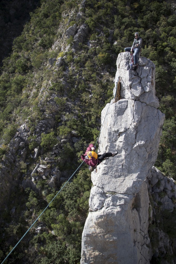 Robyn dangling in space as she crosses the tyrolean from the West Spire to the Grande Spire. 