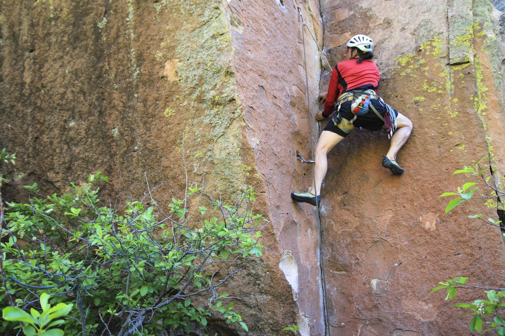 Bruno on the challenging Dos Hombres 5.11b stemming corner in Penitente Canyon.