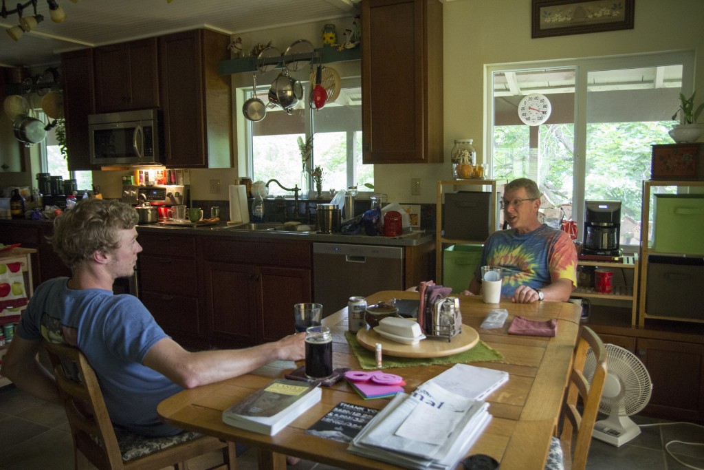 Man talk over beers in the Davis residence. 